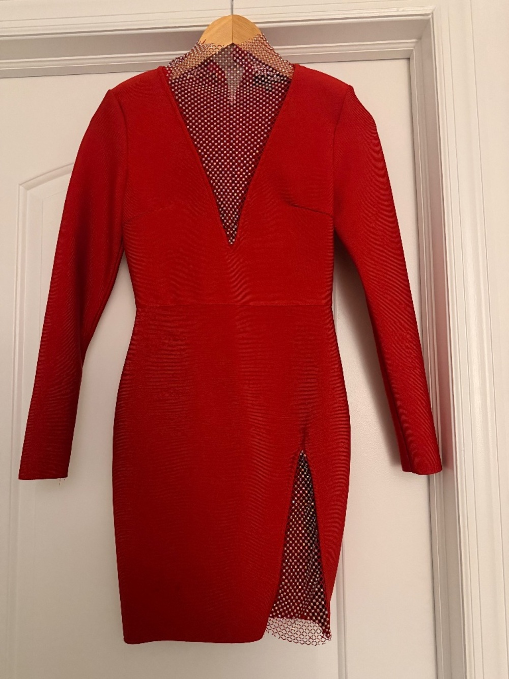 Elegant red mini dress with stunning neckline and thigh accents